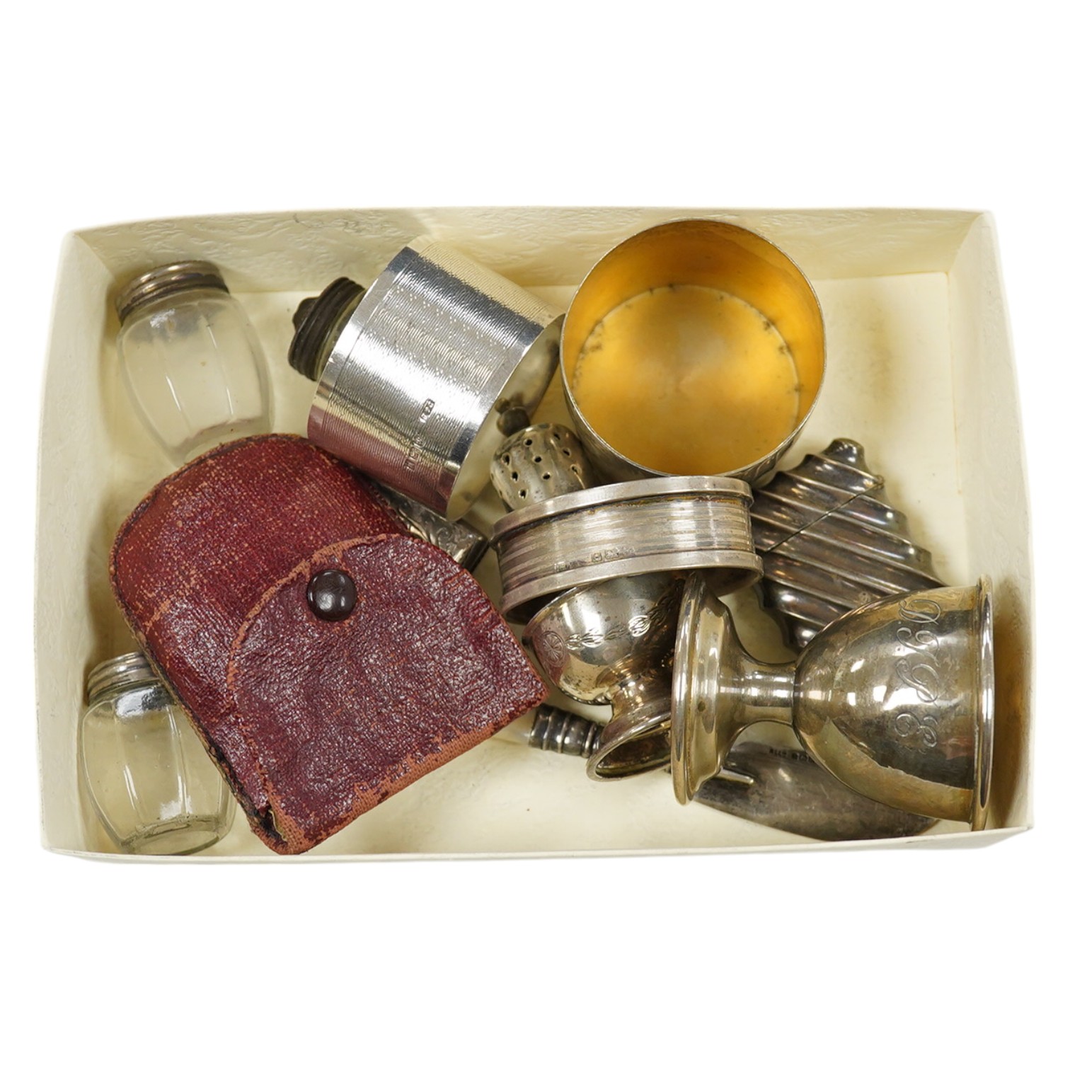 A group of assorted small silver wares including two vesta cases and two napkin rings, 5oz. of weighable silver, a mother of pearl handled butter knife, three pepperettes and a 19th century silver keywind fob watch. Cond